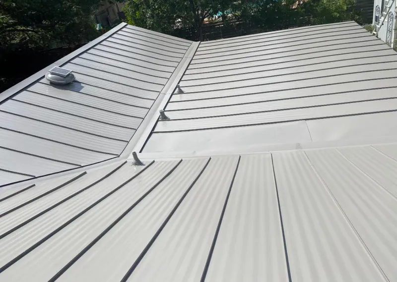 Solar attic fan installed on a metal roof for Roof Ventilation in Schroeppel